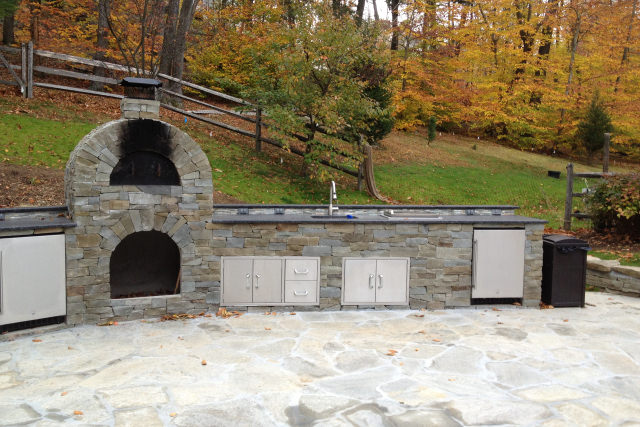 Outdoor living space with kitchen fireplace